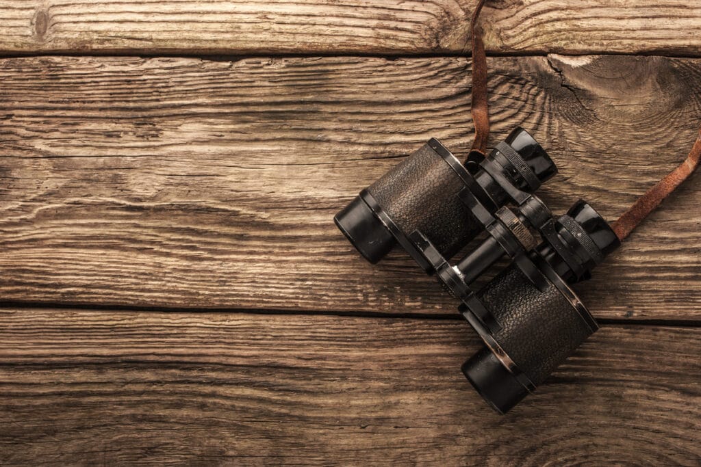 Binoculars on the wooden table