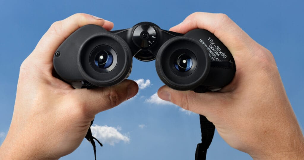 hands holding binoculars